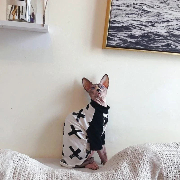 A stylish cotton sweater with a vibrant printed design and a coordinating necklace accessory, perfect for keeping your cat warm and fashionable.