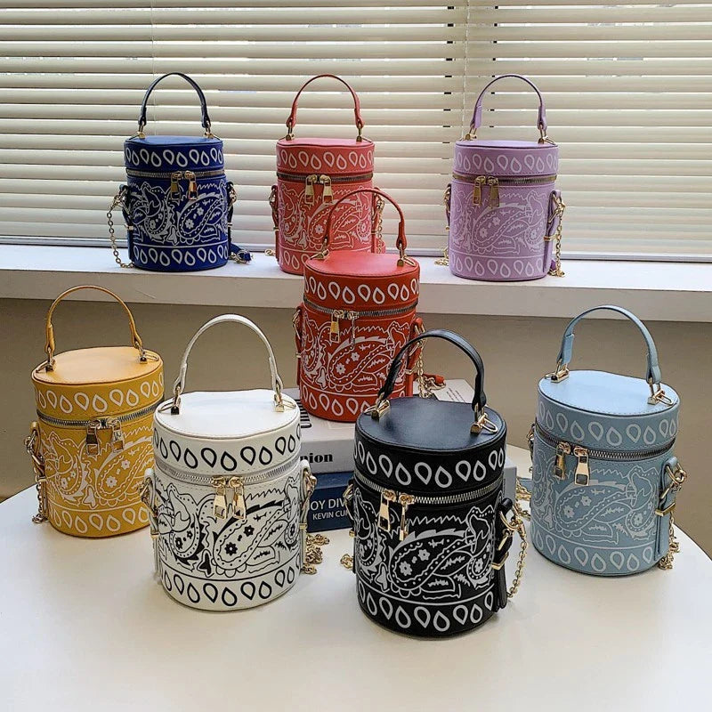 Premium PU leather bucket bag in a variety of classic and contemporary colours, featuring a spacious main compartment, adjustable shoulder strap, and sophisticated British-inspired design.
