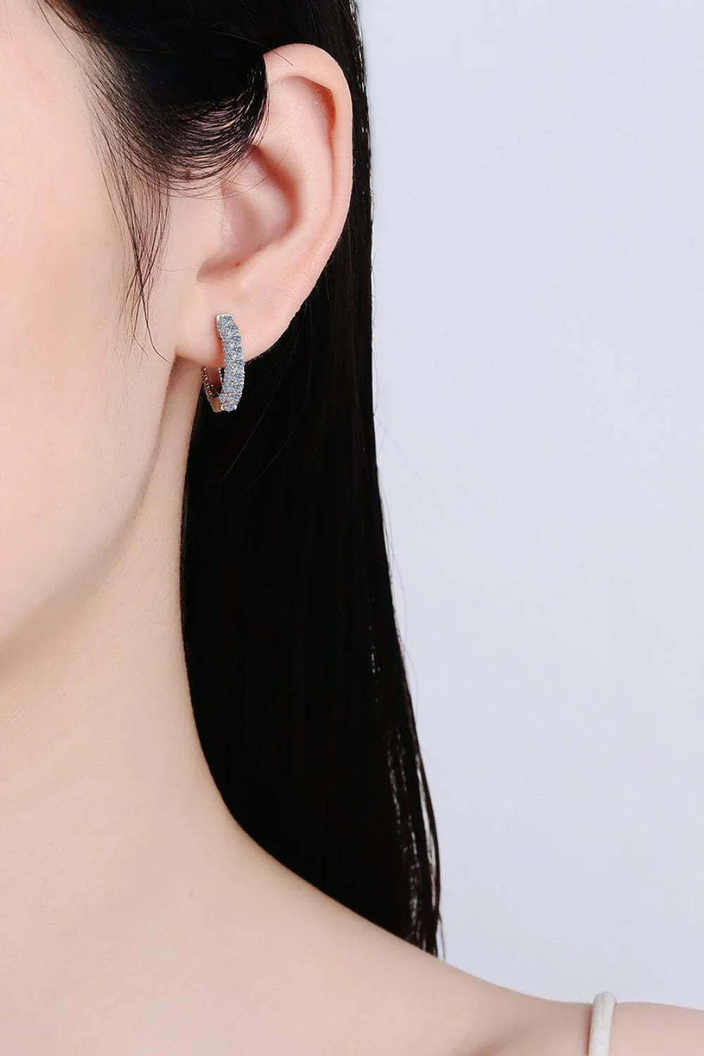 Elegant 925 sterling silver moissanite huggie earrings with a minimalist design and polished finish