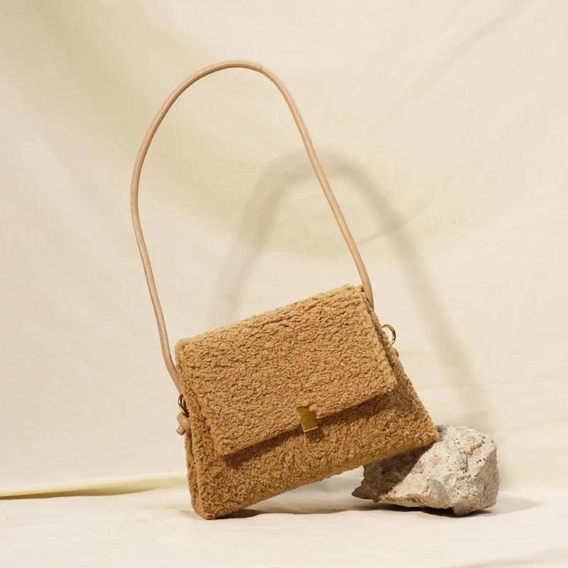 A stylish faux lamb wool crossbody bag in beige, black, or khaki brown with a contemporary design and practical storage features
