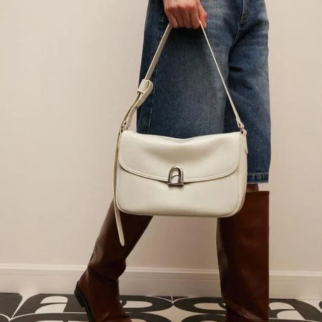 Stylish leather shoulder and crossbody bag in burgundy colour, with a square silhouette and sleek design