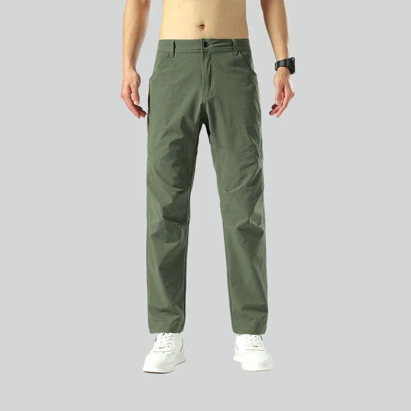 Weatherproof outdoor trousers for men in black, gray, and green colours with adjustable waistband and reinforced panels