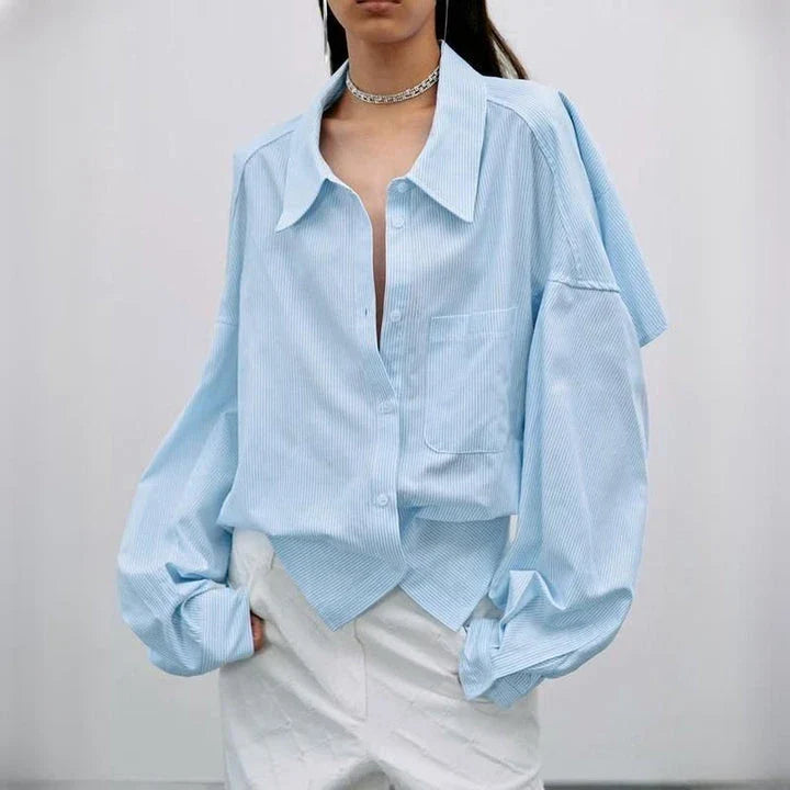A stylish patchwork blouse with functional pockets, perfect for casual and semi-formal occasions during the autumn and winter seasons.