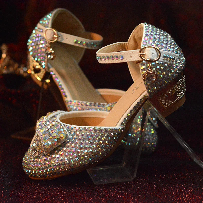 Enchanting princess crystal shoes with bow detail and dazzling crystals, perfect for girls' special occasions