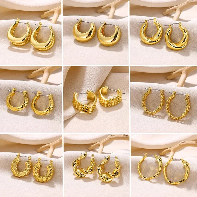 A pair of gold-toned stainless steel hoop earrings, showcasing a classic and sophisticated design