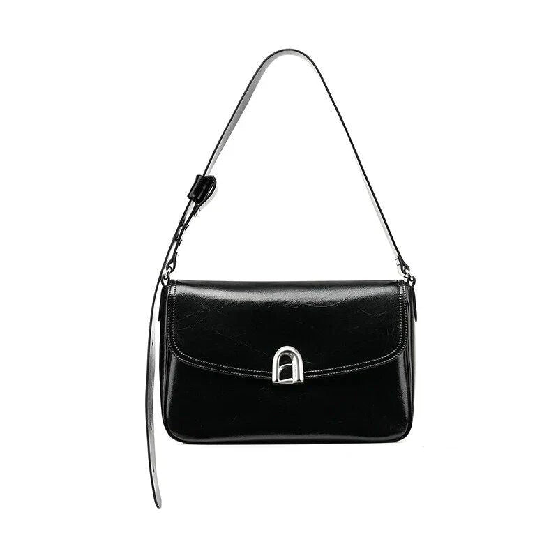 Stylish leather shoulder and crossbody bag in burgundy colour, with a square silhouette and sleek design