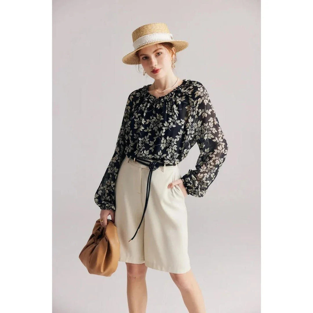 Floral silk blouse with ruffles and round neckline, showcasing the elegant and comfortable design for versatile wear.