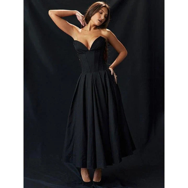 Elegant, backless A-line midi dress in black for women, featuring a sleek silhouette and sophisticated draping