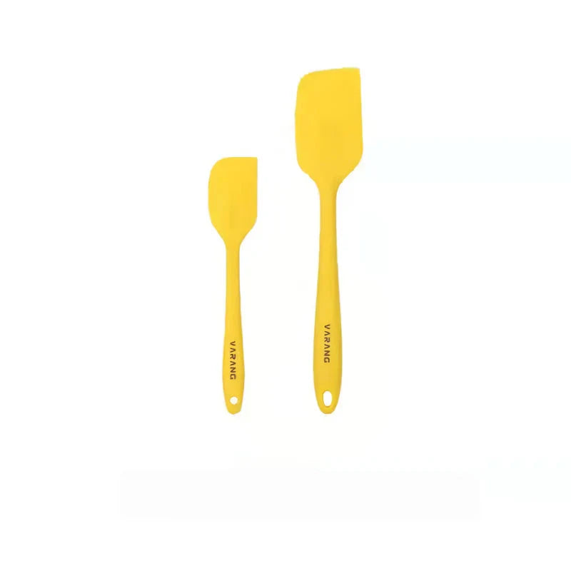 A set of two high-quality silicone spatulas in brown and yellow colours, designed for versatile cooking and baking tasks.