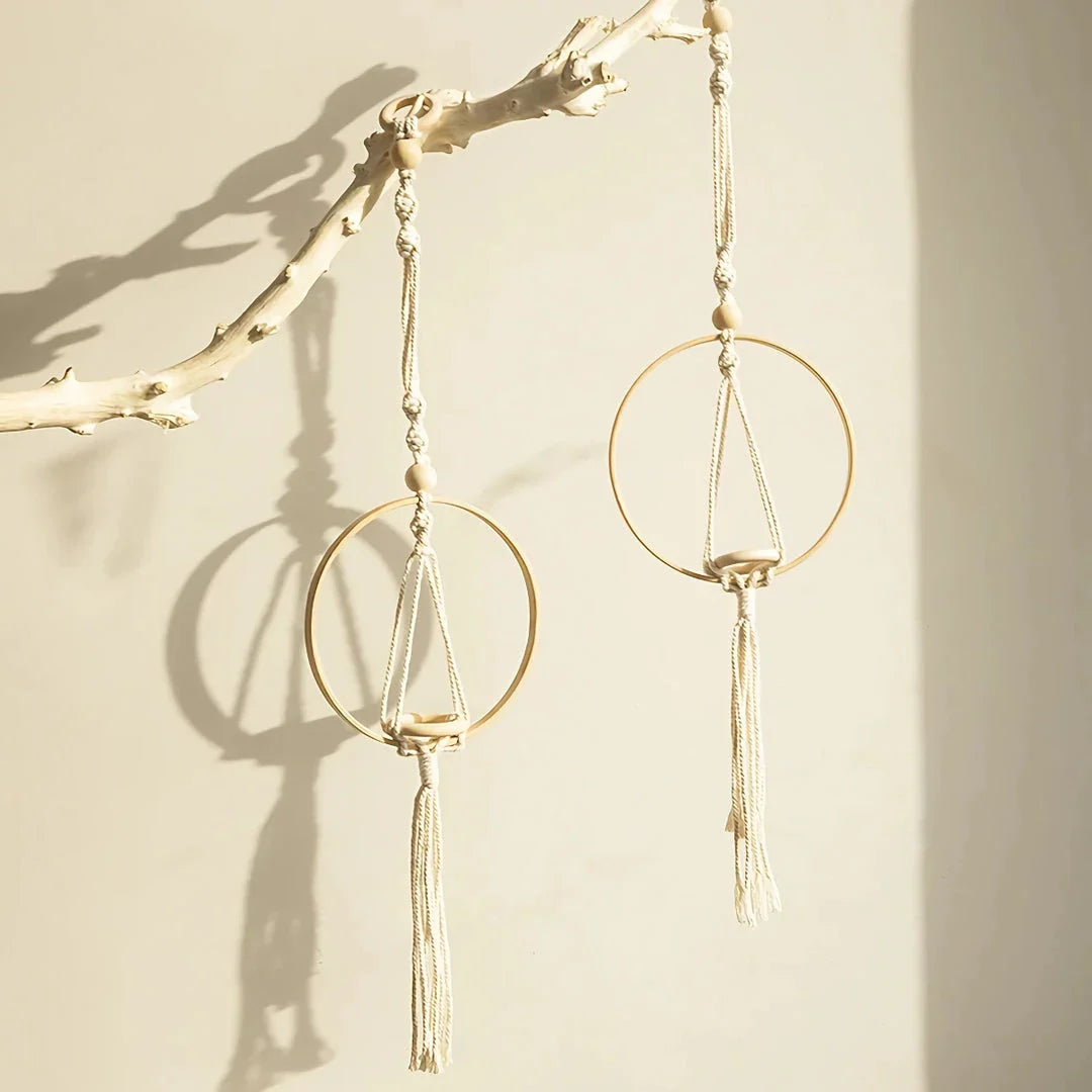 A macrame air plant hanging holder with a chic, boho-inspired design, perfect for adding organic texture and soothing vibes to any room.