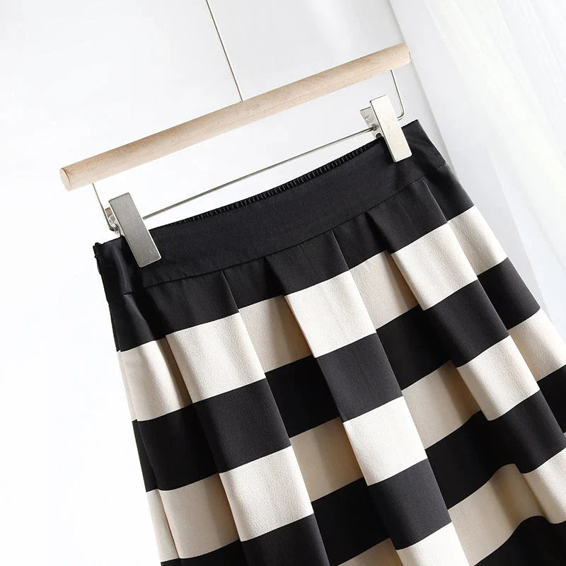 Elegant striped midi skirt with pleated design, made from premium polyester for a sophisticated and comfortable look.