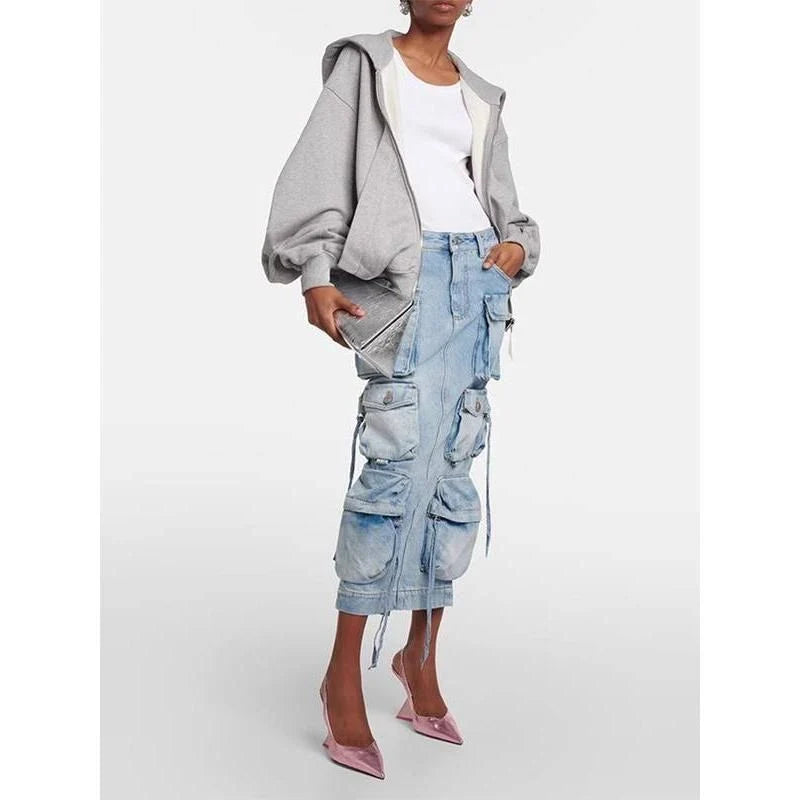 A high-waisted denim skirt with distressed detail and a ribbon slit, perfect for spring fashion