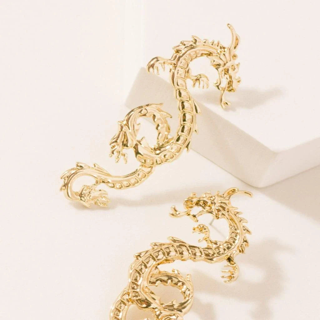 Stunning gold-coloured dragon stud earrings with intricate details, a fashionable accessory for UK customers