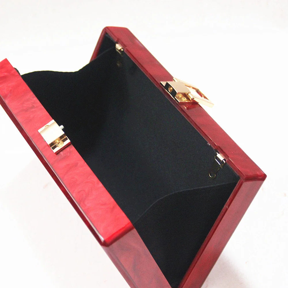 Stylish pearlescent acrylic clutch bag in red colour with a structured, square-shaped design