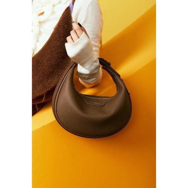 Stylish crescent-shaped leather crossbody bag with soft, supple texture for everyday elegance