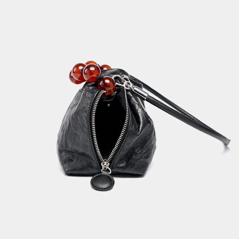 Premium leather crossbody bag with intricate beadwork, featuring a classic saddle shape and adjustable shoulder straps for versatile and secure everyday use.