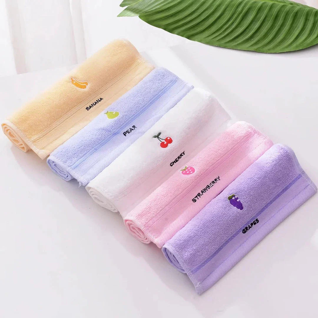 Soft cotton baby bath towel with adorable cartoon fruit face designs in pink