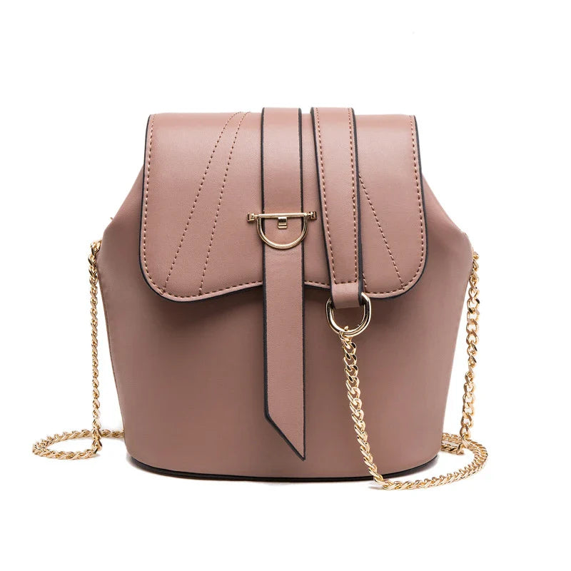 A large capacity chain bag with a classic bucket silhouette, crafted from premium leather-look material for sophisticated British style.