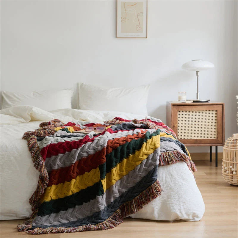 Elegant wool blanket with stylish plaid pattern and fringed tassels, perfect for cosy home decor and outdoor adventures.