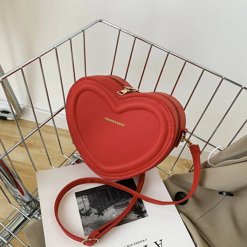 Chic heart-shaped crossbody bag made from premium PU leather, available in multiple stylish colours