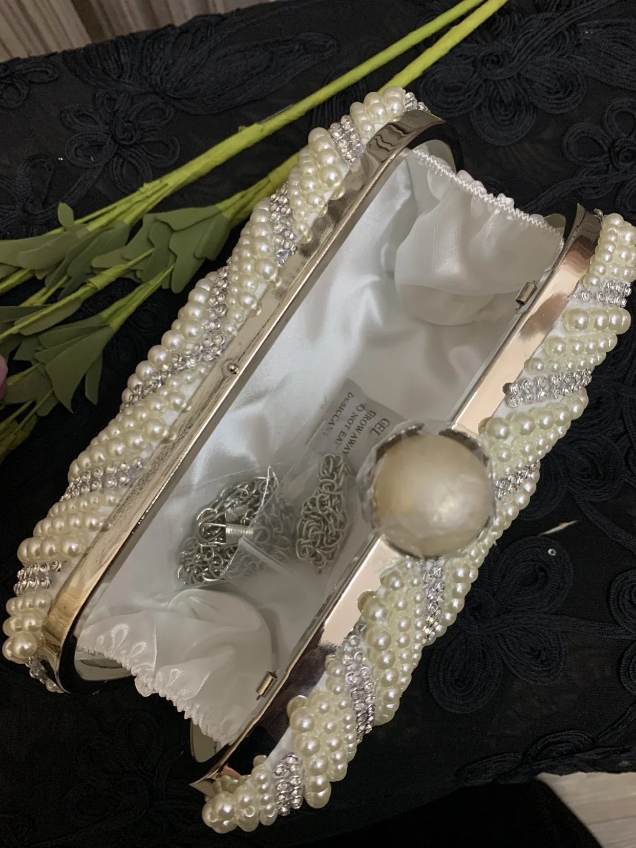 Sophisticated gold cheongsam handbag with pearlescent charm, a compact and stylish accessory for formal and casual occasions