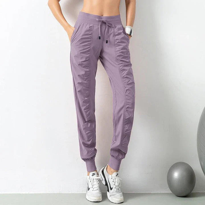 Premium women's sports trousers with drawstring waist and pockets, made of high-quality nylon fabric for comfort and versatility.