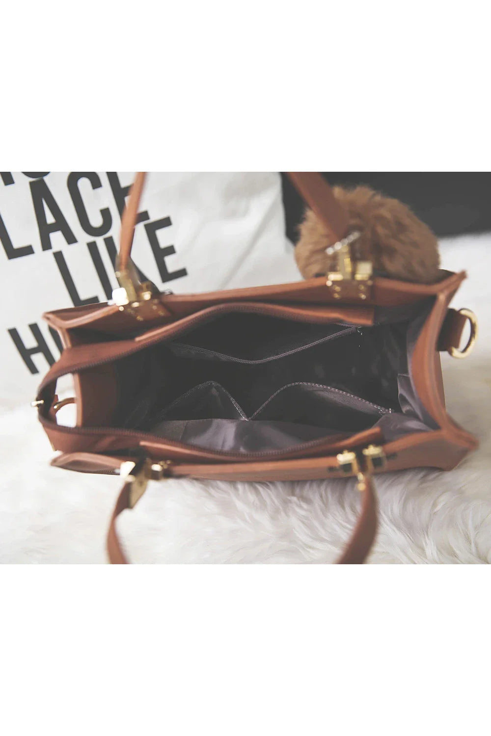 A stylish and versatile shoulder bag with a pom-pom accent, perfect for everyday use and special occasions.