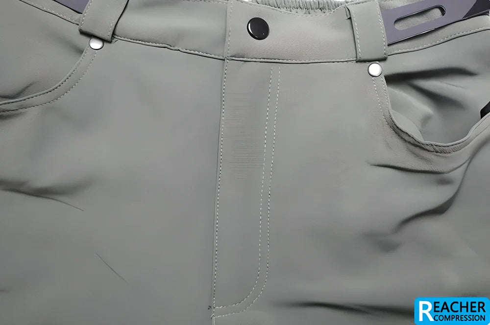 Men's cycling shorts in black and green colours, with adjustable waistband and zipper pockets for storage