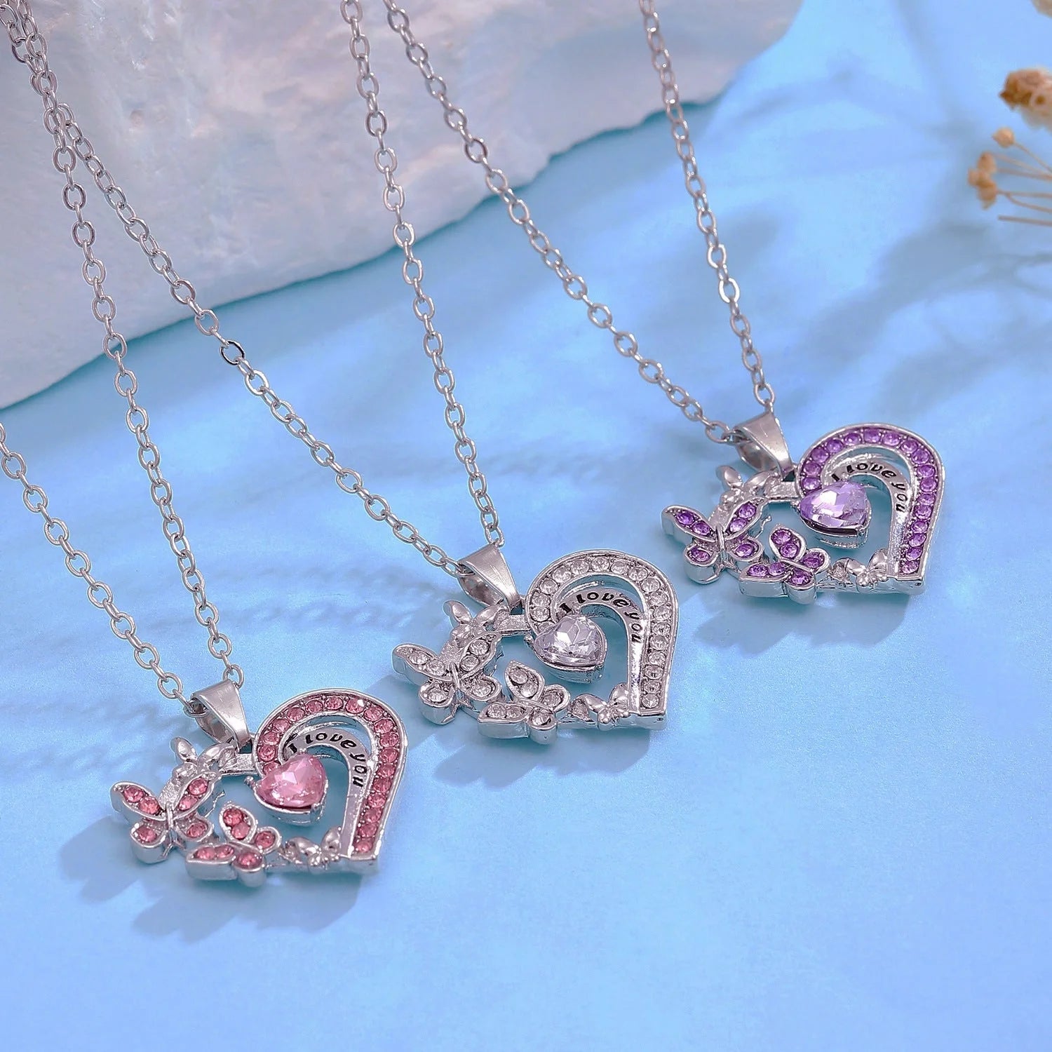 Butterfly Love Necklace with rhinestones and hollow heart-shaped pendant in white, purple, or pink