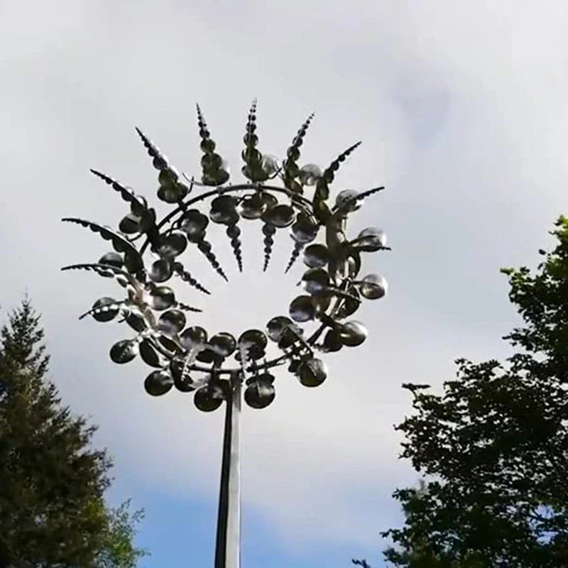 Elegant revolving metal windmill outdoor ornament with dual-layered blades creating a mesmerizing display in the garden
