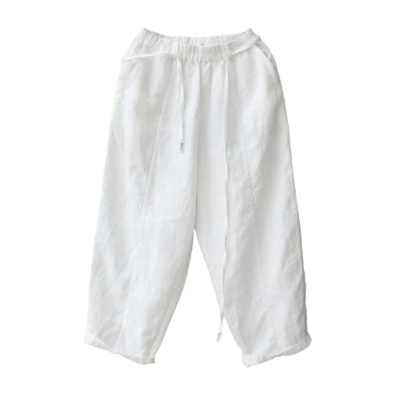 Elegant white linen trousers with a relaxed, artistic silhouette and cropped length