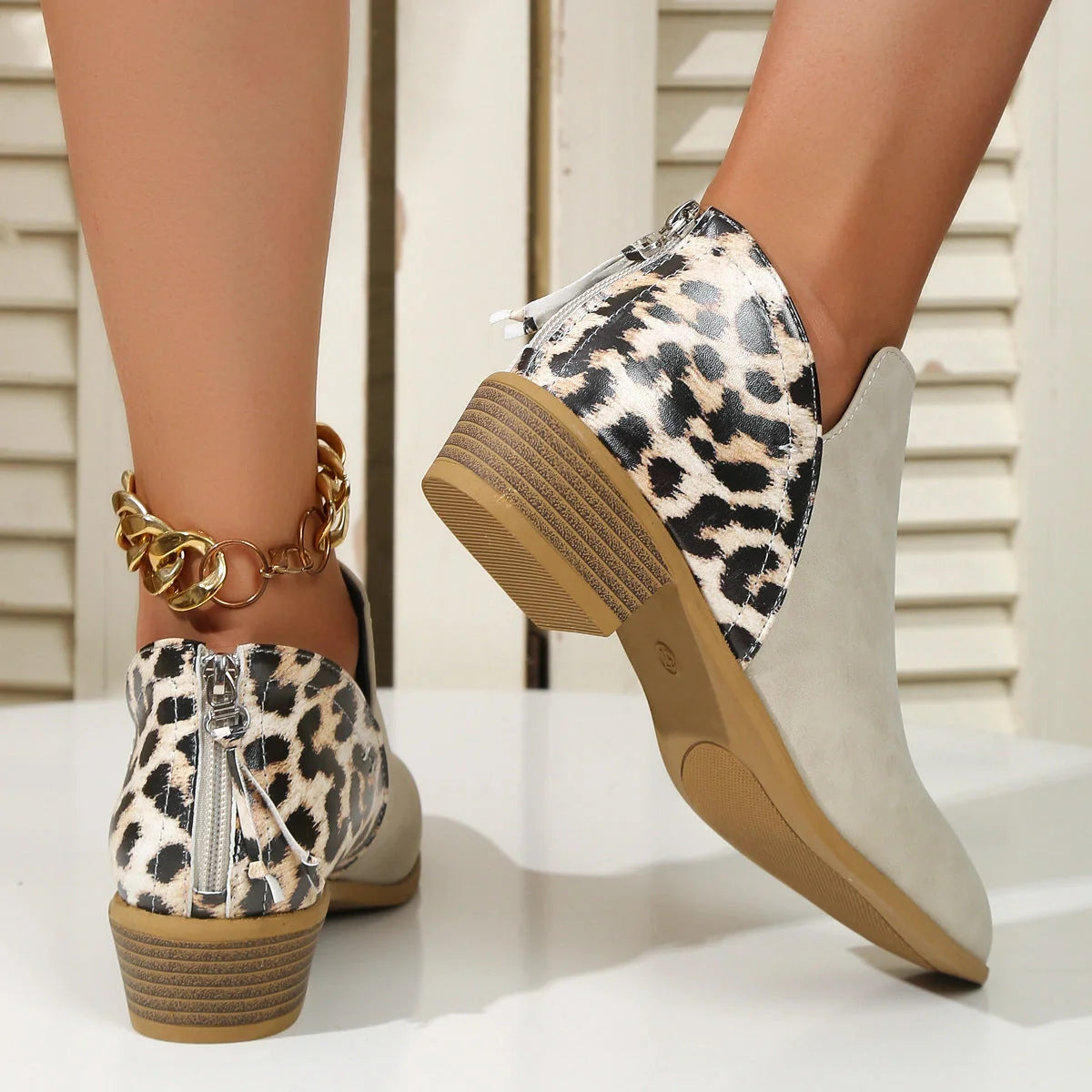 Women's leopard print boots with pointed toe and chunky heel, available in multiple sizes