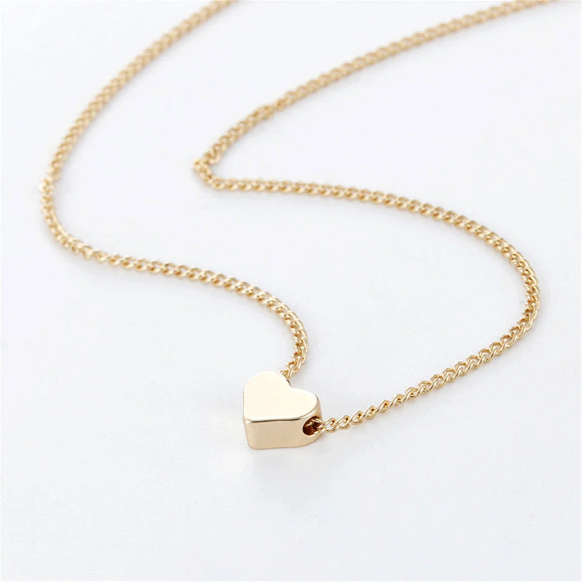 Elegant gold-tone double-sided love pendant necklace with a sleek clavicle chain design