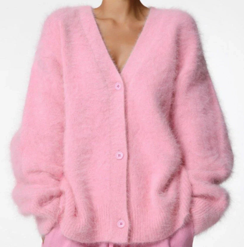 A stylish loose knit cardigan in a variety of colors, featuring a v-neck design and single-breasted closure for a flattering, relaxed fit.