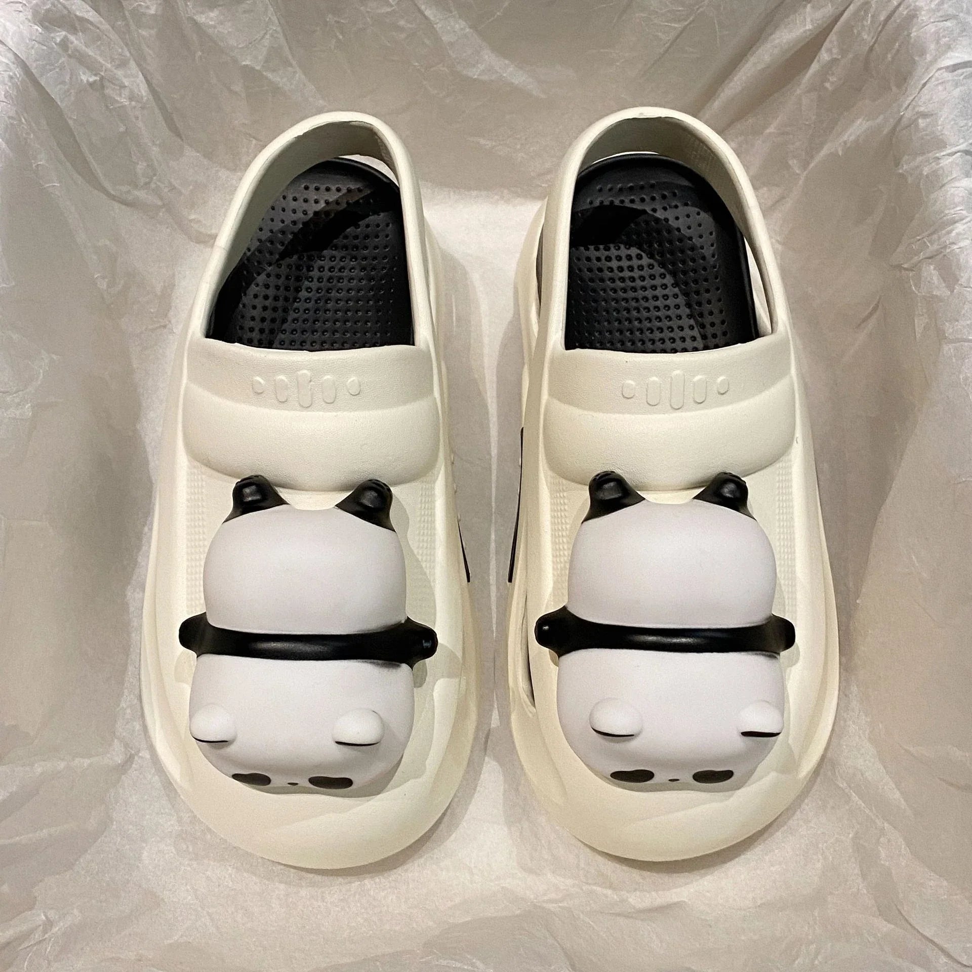 Adorable panda-themed slip-on slippers in various colors and sizes, featuring a lightweight and breathable design for comfortable everyday wear.
