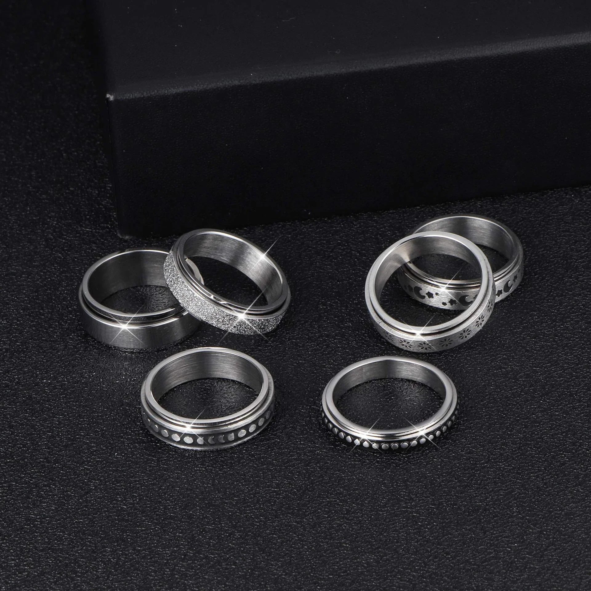 Elegant stainless steel spinner ring with a captivating moon and star design that rotates effortlessly for a calming tactile experience