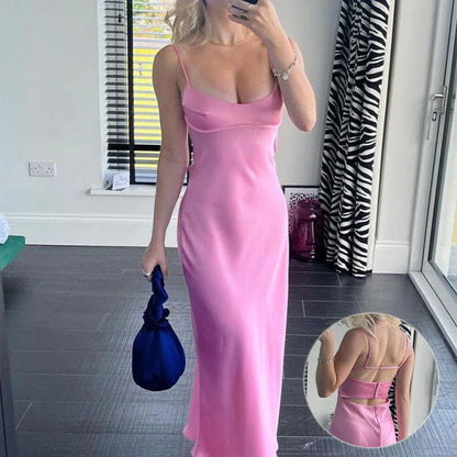 A sleek and elegant satin slip dress in a stunning pink color with a backless design and full-length silhouette.