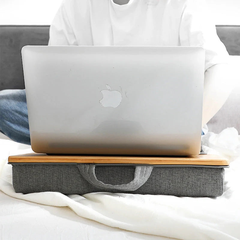 Elegant bamboo lap desk with cushioned surface and card slots for relaxing laptop use