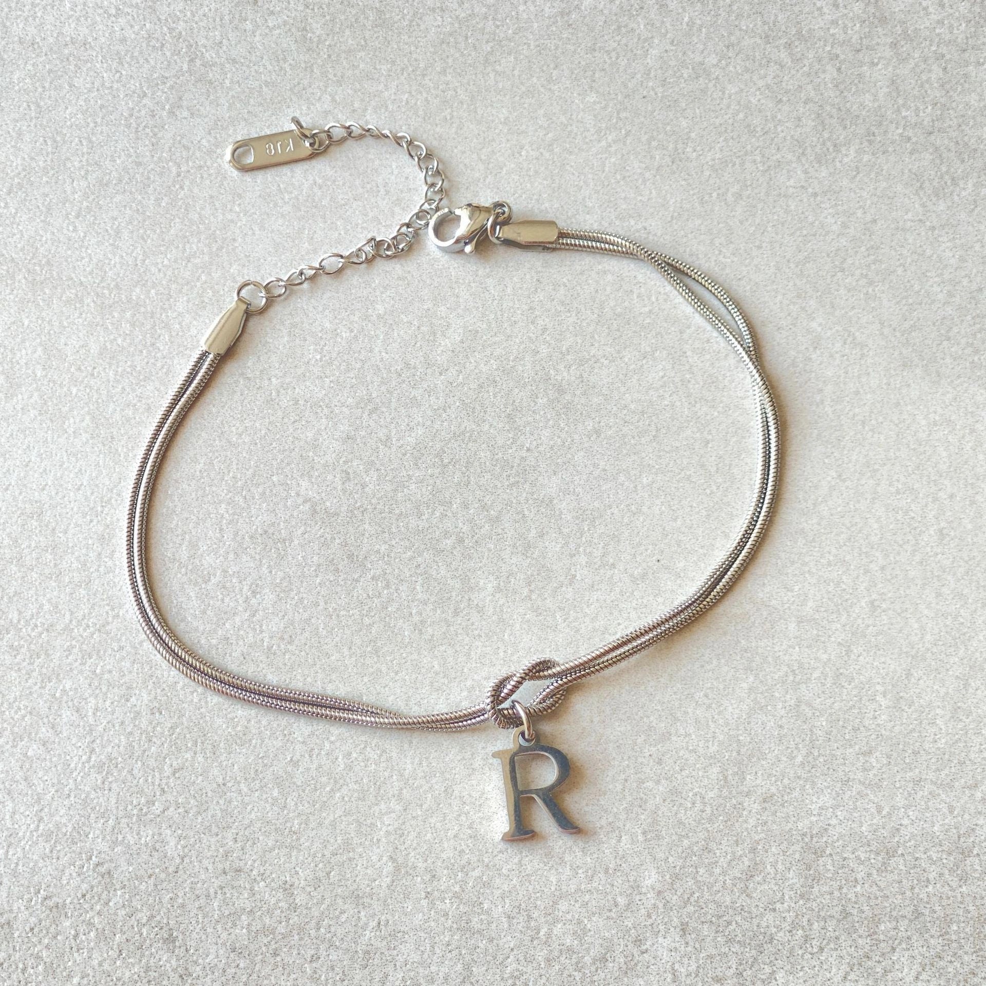 Personalised gold and silver love knot bracelets for couples, perfect as Valentine's Day gifts.
