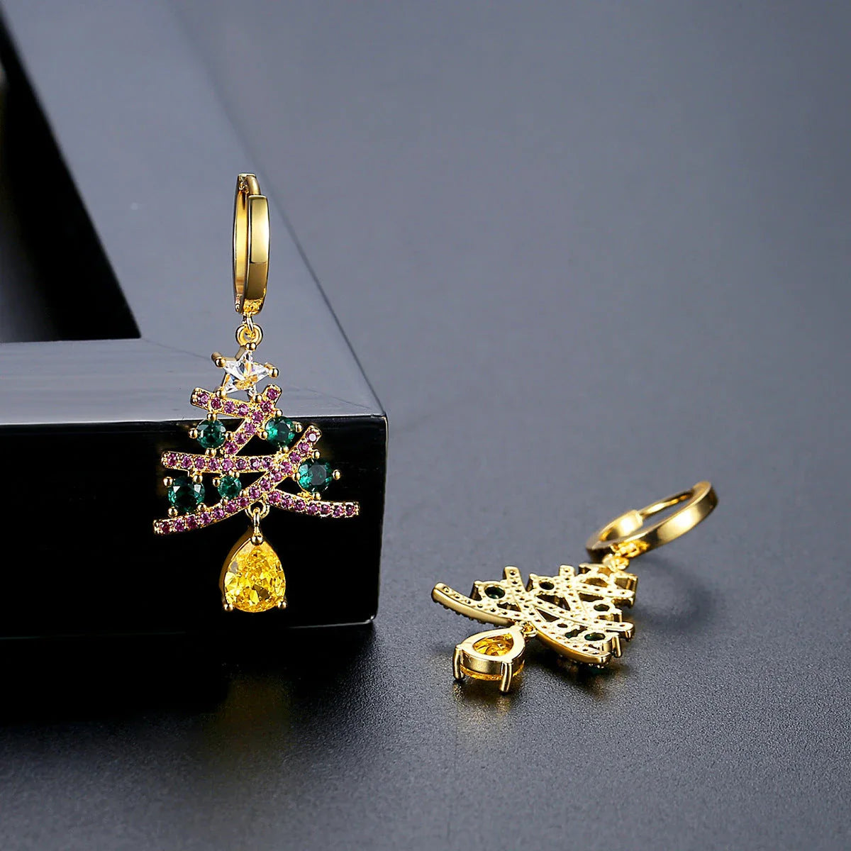Pair of elegant Christmas tree earrings with a geometric design, sparkling rhinestones, and 18K gold electroplating