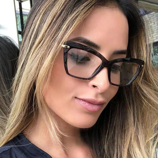 Women's anti-blue light cat eye glasses in transparent pink, bright black, transparent grey, and transparent tea