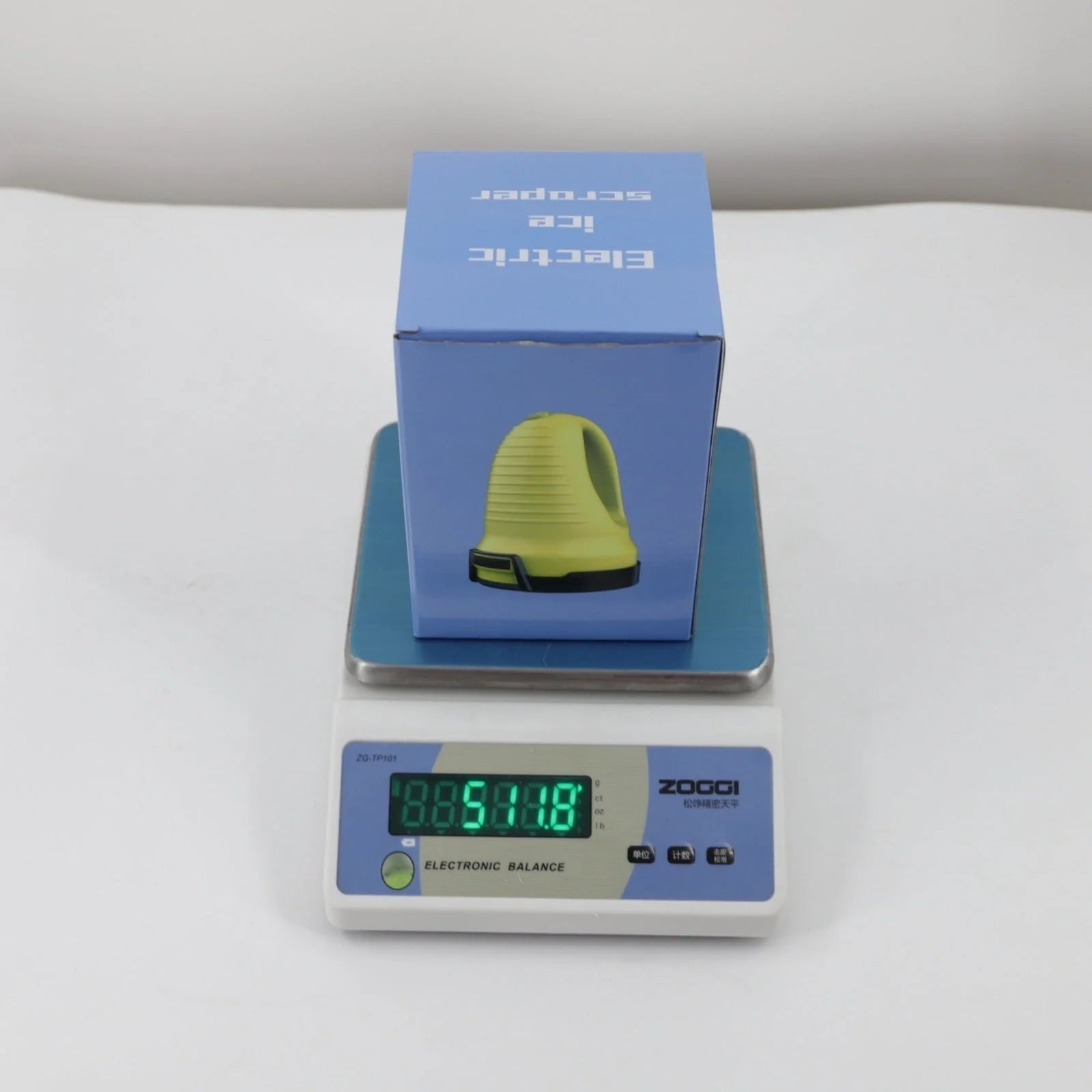 Electric snow scraper with yellow body and rotating disc for ice removal