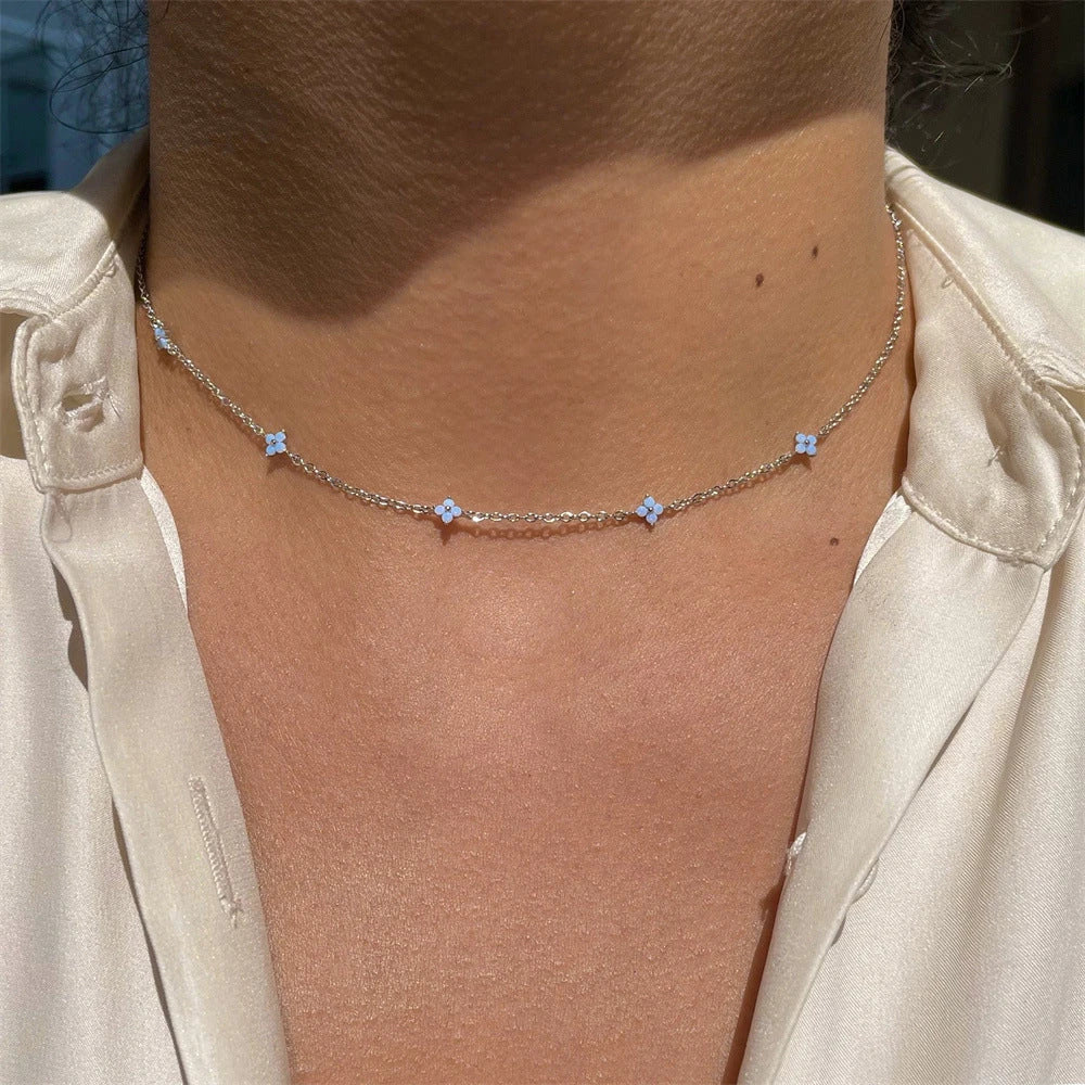 Elegant floral statement necklace in various color options, including golden blue, silver blue, golden green, and silver green, with an adjustable chain and high-quality construction.