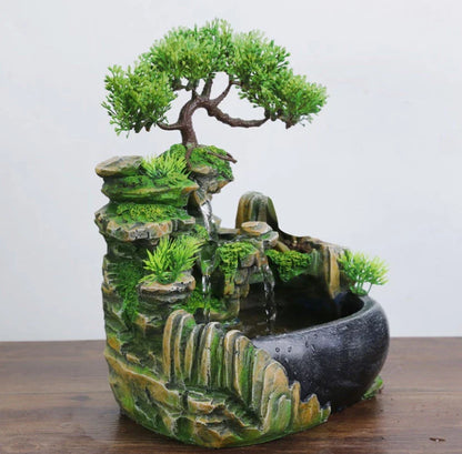 A desktop water feature with a rockery design, flowing water, and an optional mist function for creating a calming and relaxing ambience in home or office spaces.