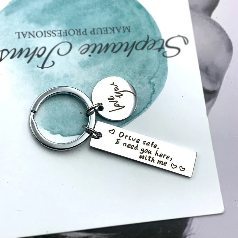 Unisex stainless steel safe driving keychain with elegant lettering