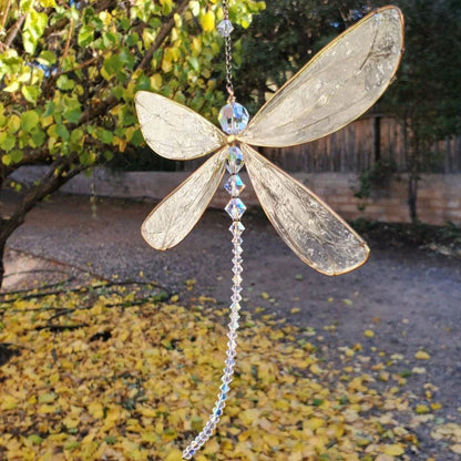 Dragonfly-shaped crystal suncatcher that creates a vibrant rainbow display when exposed to sunlight, perfect for garden, wedding and home decor