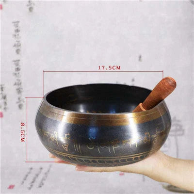 A handcrafted Tibetan singing bowl made of copper, used for meditation and relaxation.