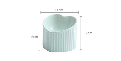 Elevated ceramic pet bowl with angled design for comfortable, natural feeding of cats and dogs