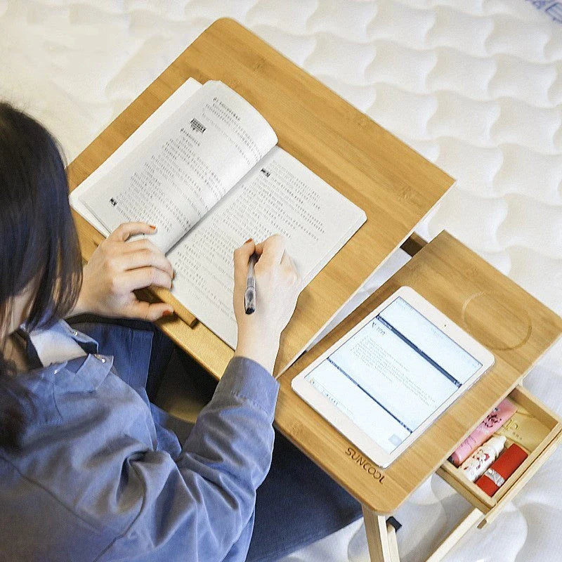 Ergonomic bamboo laptop desk with storage drawers, adjustable legs, and cooling fan for comfortable home office use
