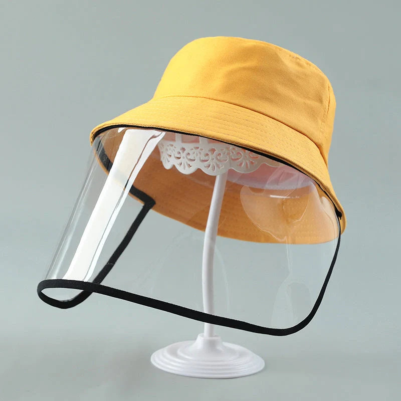 Child wearing anti-spitting protective hat with transparent bezel